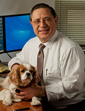 Michael A. Totilo at his desk with his dog